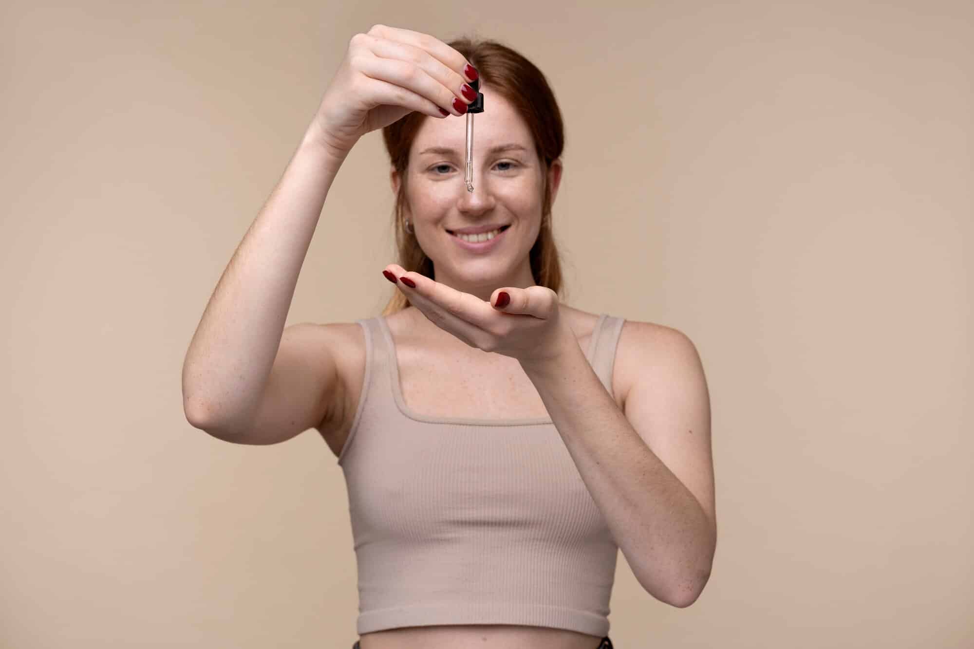 woman with dropper in hand image