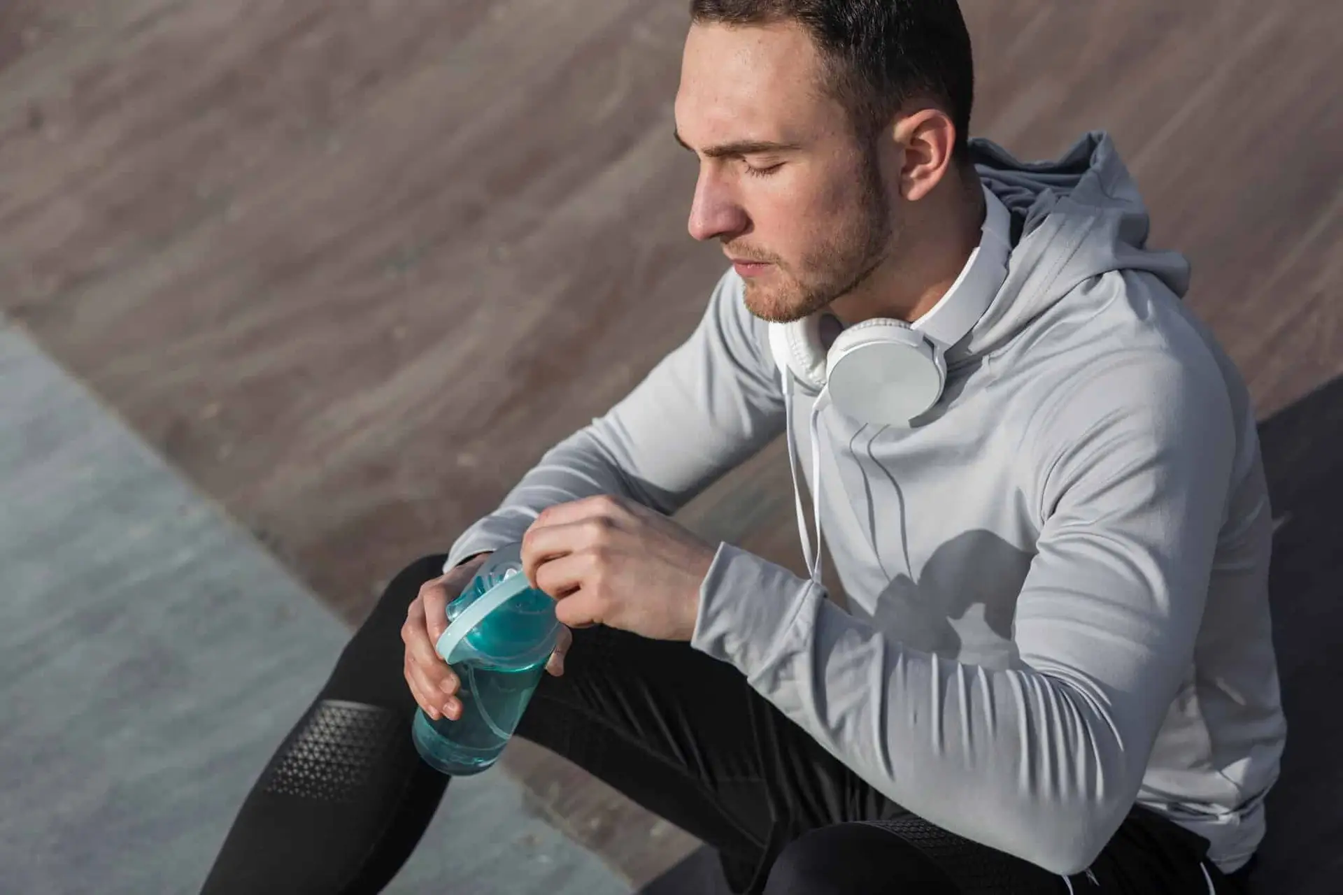 man with eyes closed and water bottle image