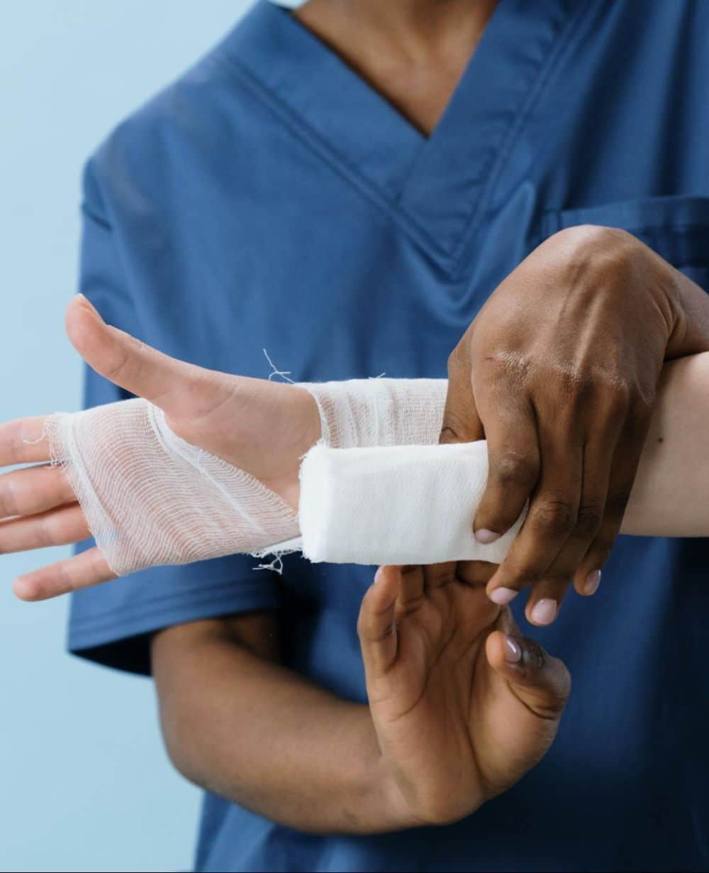 hand being bandaged by nurse image
