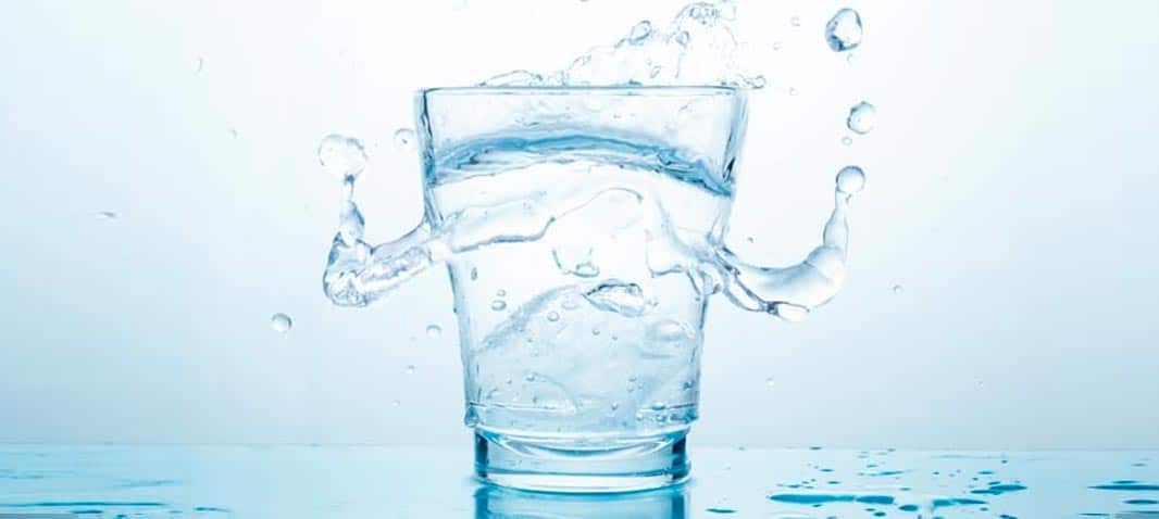 glass of water with splashing droplets image