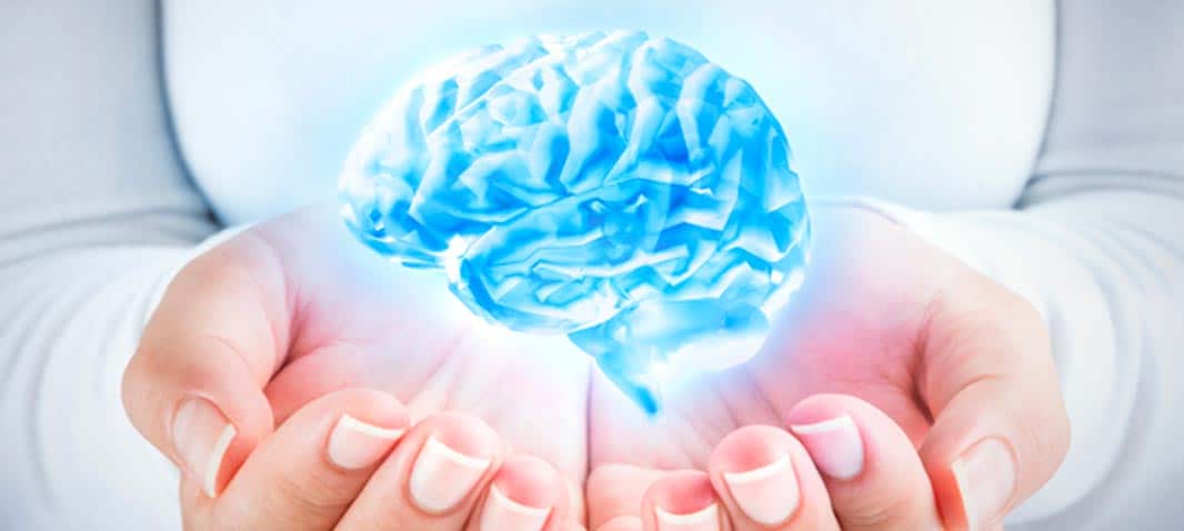 blue glowing brain in hands image